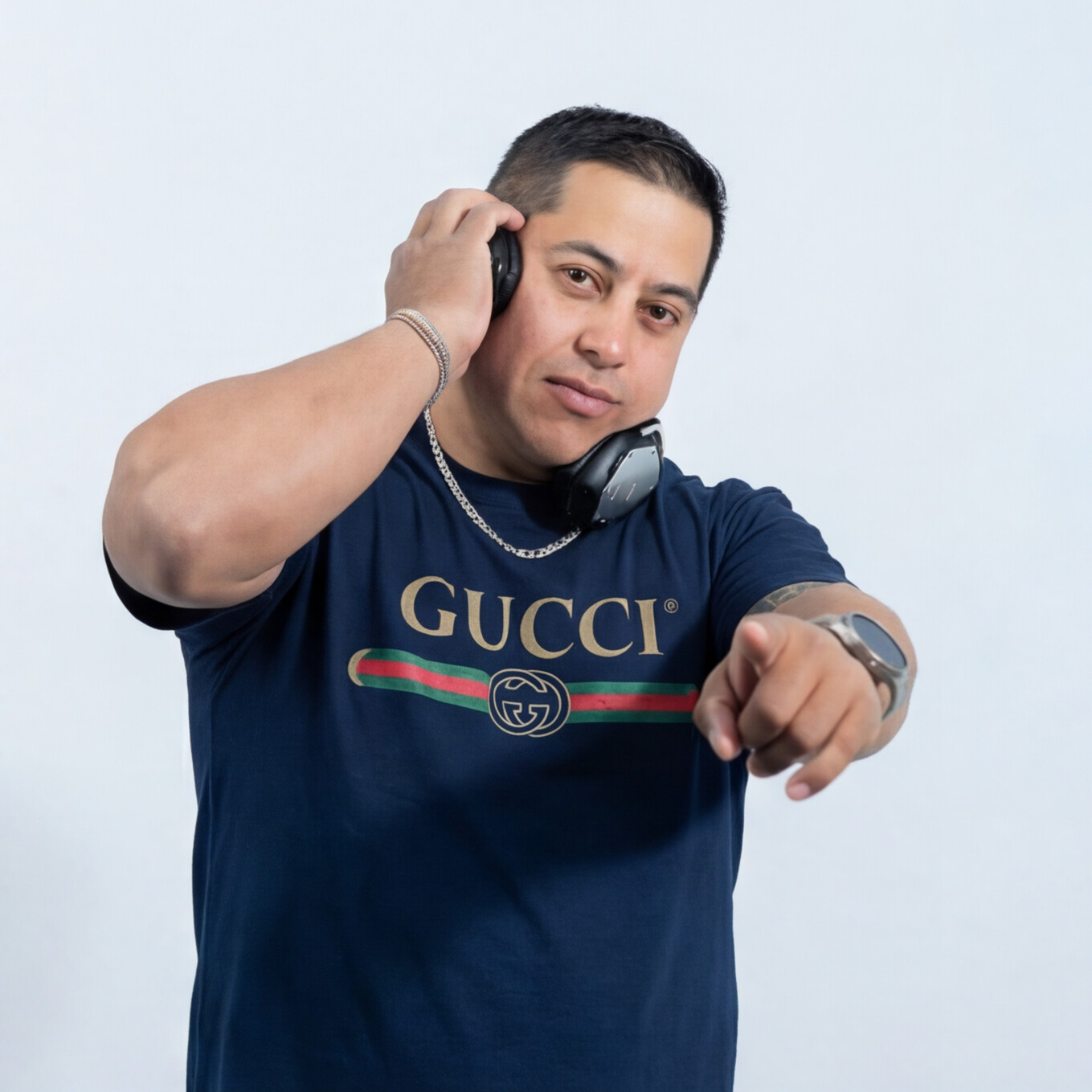 DJ Xander wearing headphones and a blue shirt